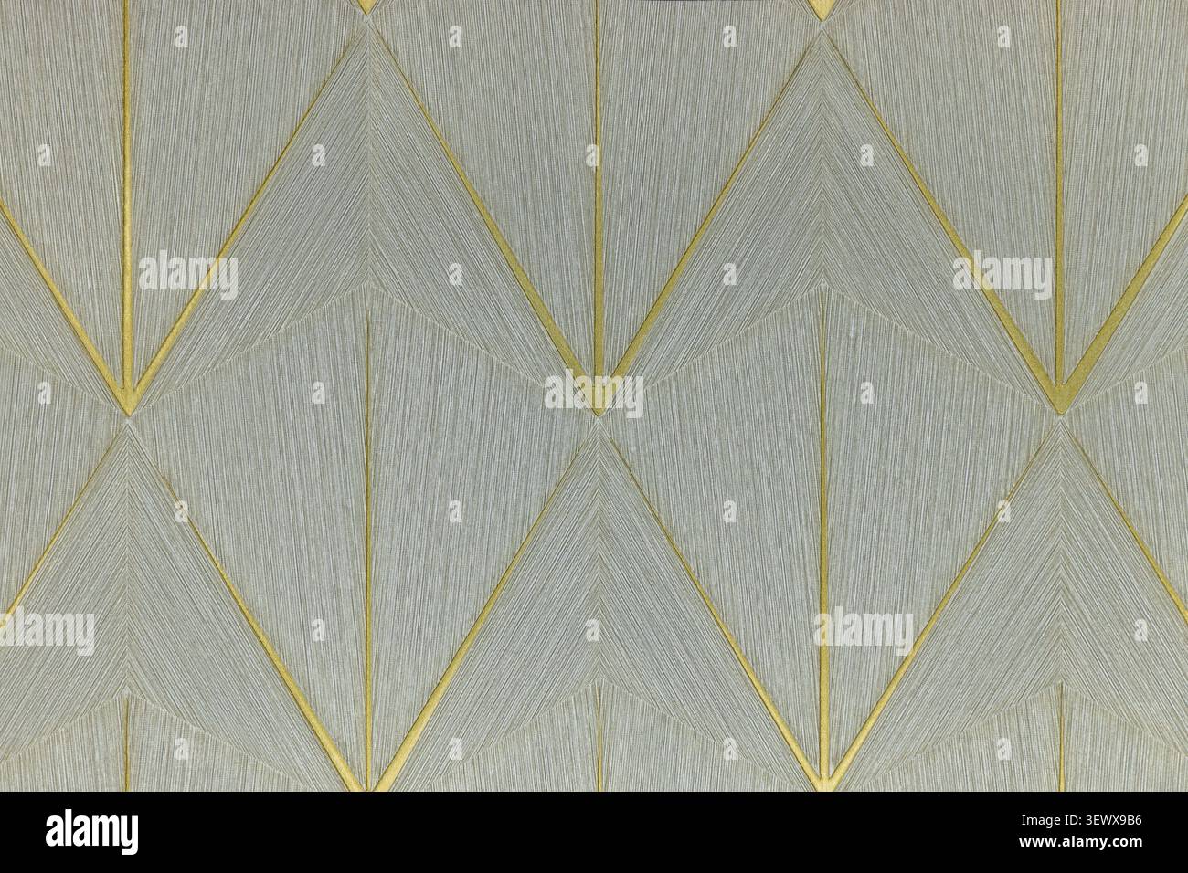 Geometrische goldene Linien auf grauem, strukturiertem Hintergrund Stockfoto