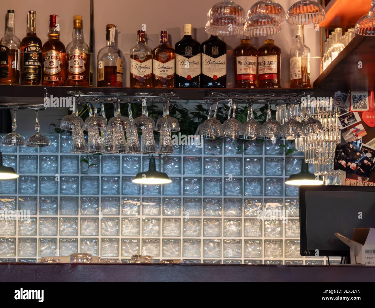 Kiew, Ukraine - 21. März 2026: Auf einem eleganten Barregal über einer Gitterglaswand befindet sich eine Auswahl an legendären Whiskey-Flaschen, die perfekt eine Raffinesse einfangen Stockfoto