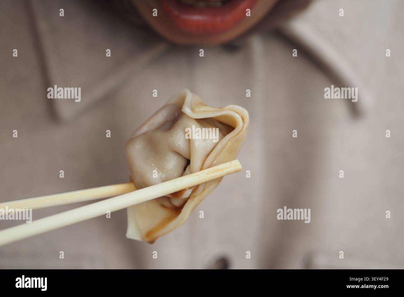 Genießen Sie Klöße mit Essstäbchen in einer gemütlichen Umgebung Stockfoto