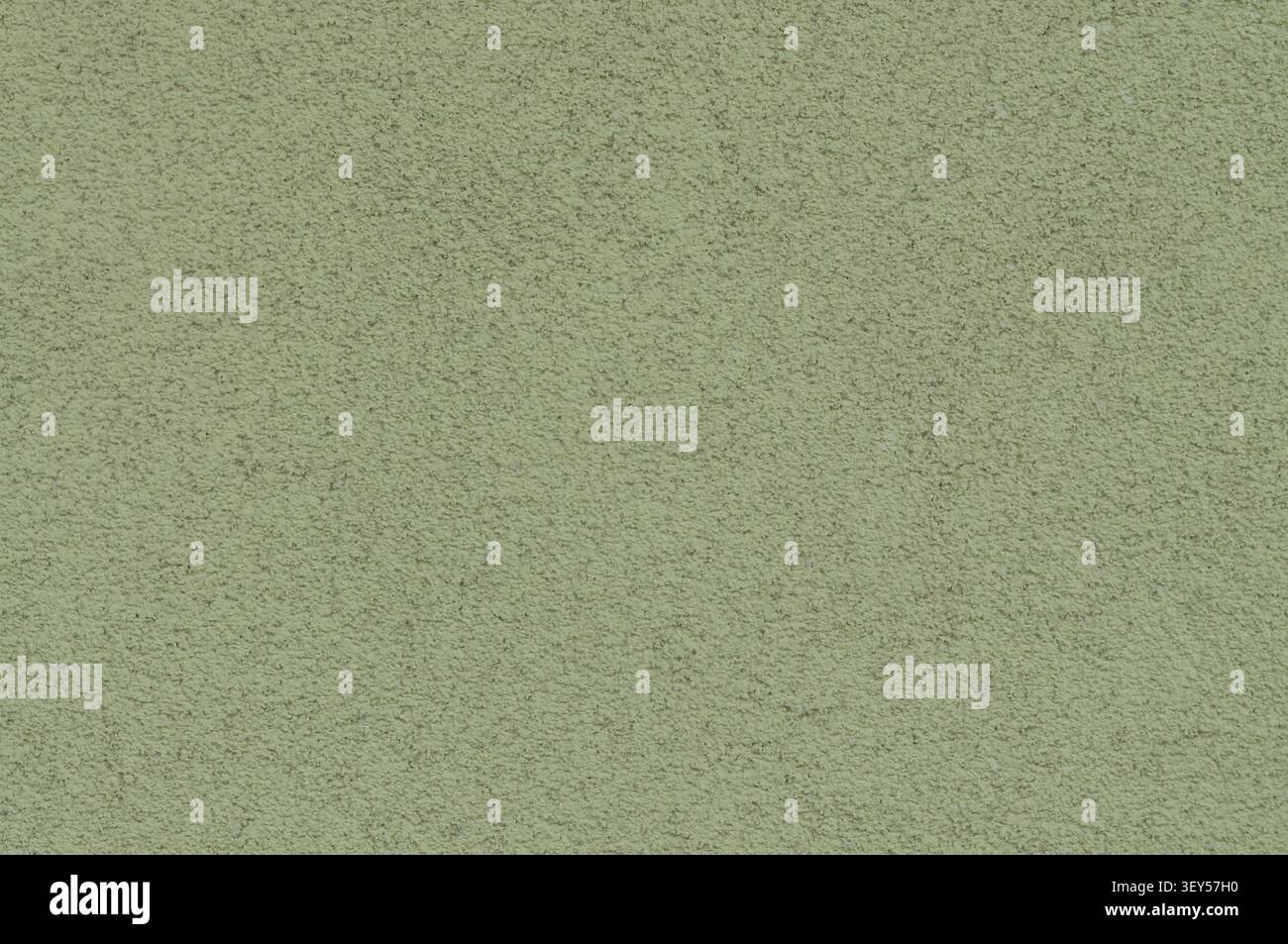 Nahaufnahme einer grünen strukturierten Oberfläche mit feiner, körniger Textur und leichten Unebenheiten, die ein Hintergrund- oder Hintergrundbild erzeugt. Stockfoto