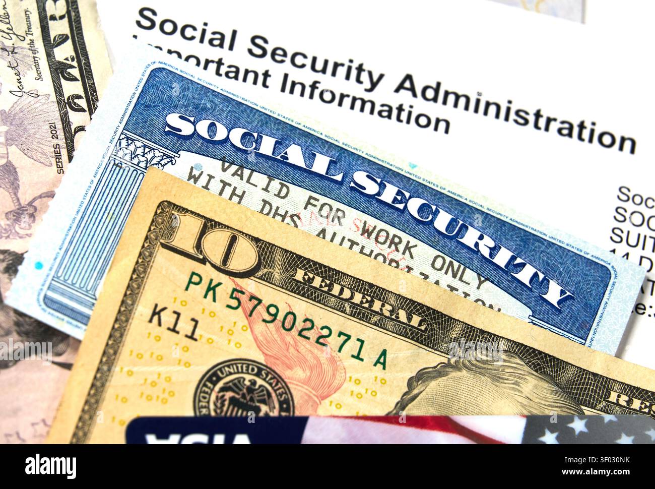 CARROLLTON, TX, USA - 22. FEBRUAR 2024: Nahaufnahme einer Sozialversicherungskarte mit US-Währung und einem Brief des Sozialversicherungs-Adminis Stockfoto