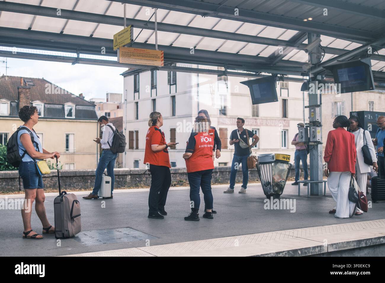 SNCF Inoui-Zugpersonal steht auf dem Bahnsteig zwischen Passagieren, die darauf warten, den Zug an einer französischen Bahnhofsstation zu besteigen. Reisen, Frankreich. Stockfoto