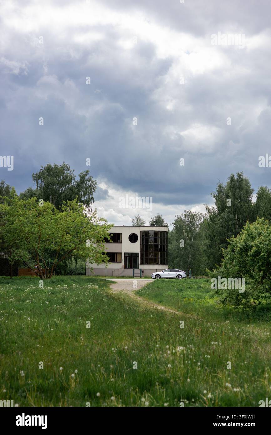 Villa im modernen Stil mit Luxus-Sedan-Auto auf dem Rasen Stockfoto