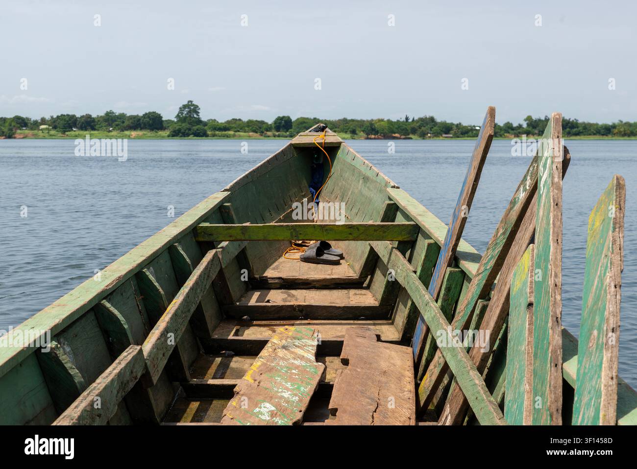 Holzkanu-Bug, der ruhige Flussgewässer überquert, Volta-Region, Ghana Stockfoto