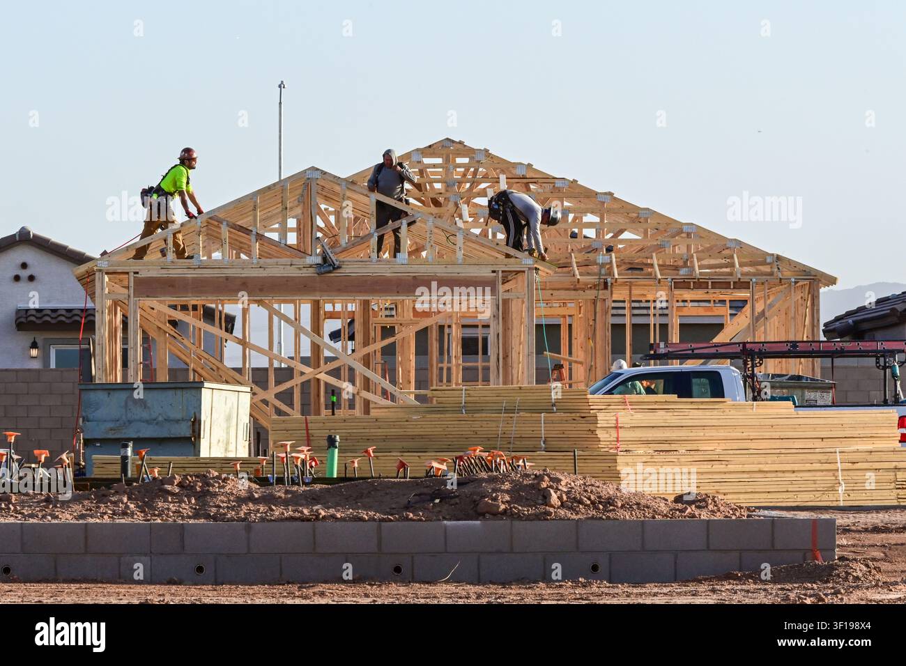 Apache Junction, Arizona, USA. 11. Juli 2026. Arbeiter bauen ein Einfamilienhaus in einer Wohnsiedlung in Pinal County, Arizona. Der Bau von Einfamilienhäusern in den USA ist kürzlich auf einen Achtmonatstief gefallen, da hohe Hypothekenzinsen und gestiegene Baukosten weiterhin die neue Wohnungsbauaktivität belasten. Trotz des nationalen Rückgangs geht die Wohnsiedlungsentwicklung in Zentralarizona weiter, während Bauunternehmer daran arbeiten, das langfristige Bevölkerungswachstum und den Wohnungsbedarf zu decken. (Bildnachweis: © Eduardo Barraza/ZUMA Press Wire) NUR FÜR REDAKTIONELLE NUTZUNG! NICHT FÜR KOMMERZIELLE NUTZUNG! Stockfoto