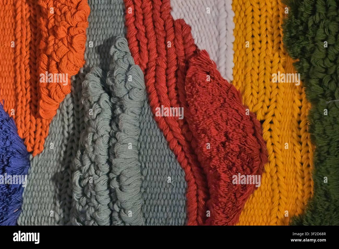 Farbenfrohe Garn- und gewebte Textilfasermuster von gestrickten Texturen, Schlaufen, handgefertigten Mustern. Kreativer Hintergrund für Textildesign, Weben, Handwerk Stockfoto