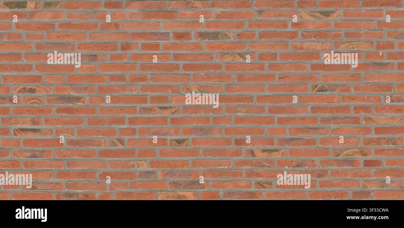 Eine saubere und gleichmäßige Wand aus modernen orange-roten Ziegeln mit dünnen, ordentlichen Mörtelfugen. Stockfoto