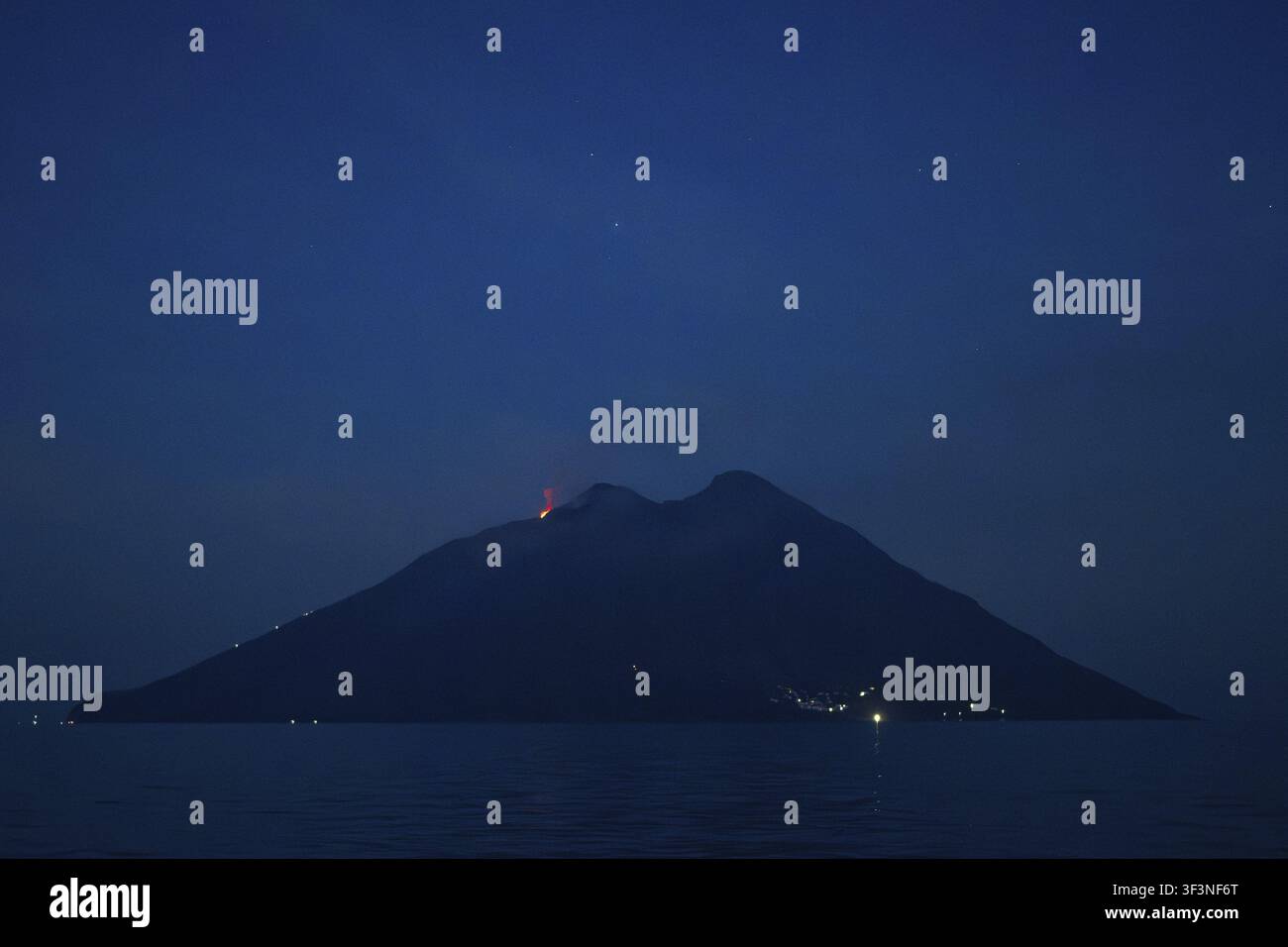 Vulkanausbruch bei Nacht mit leichtem Rauch über dunklem Meer, Stromboli-Vulkan, Stromboli-Vulkan, Äolische oder Liparische Inseln, Tyrrhenisches Meer, Sizilien, Süden Stockfoto