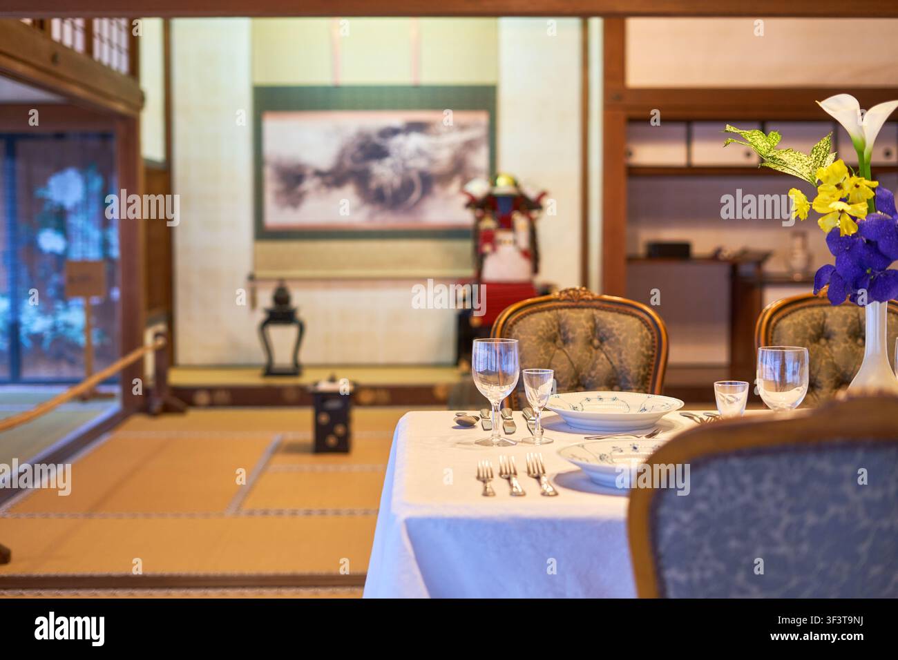 Ein traditionelles japanisches Interieur mit einer westlichen Esszimmer-Einrichtung. Der Raum verfügt über Tatami-Mattenböden und hölzerne architektonische Elemente. In der Stockfoto