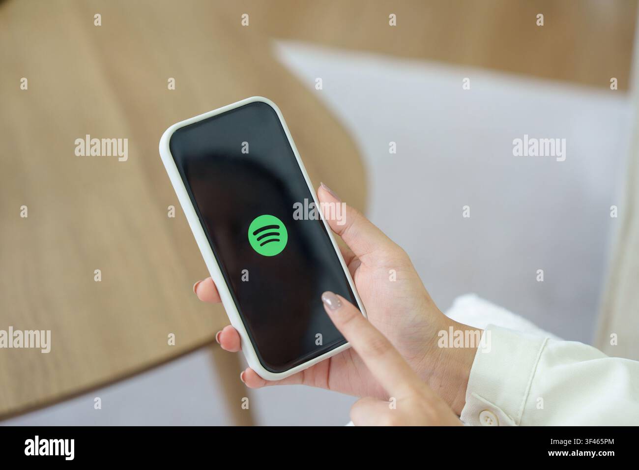 CHIANGMAI 23. Juli 2026: Hand hält ein Handy mit Spotify-Logo in horizontaler Komposition Stockfoto