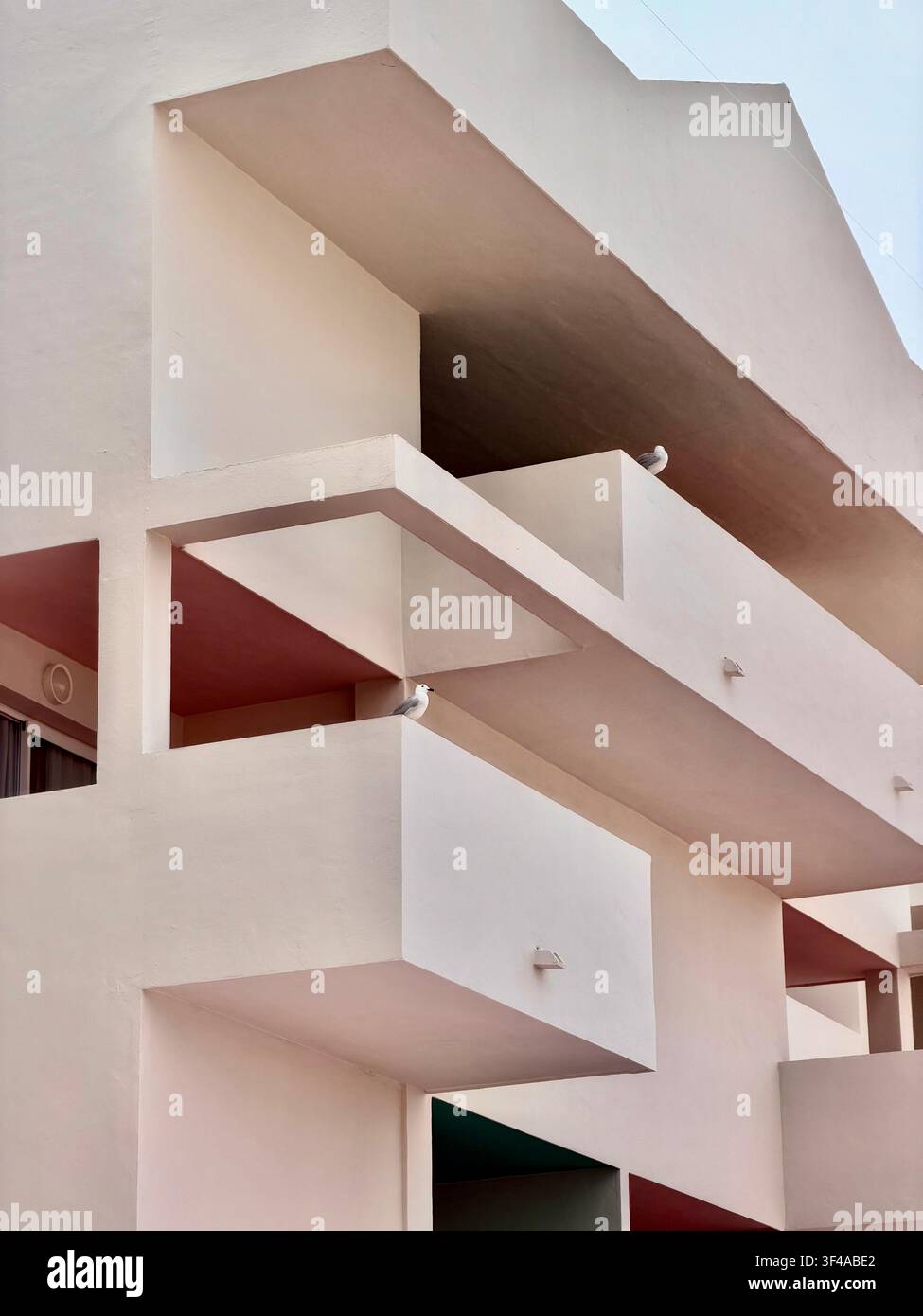 Abstrakte geometrische Balkone eines minimalistischen weißen Gebäudes in Ibiza, Spanien Stockfoto