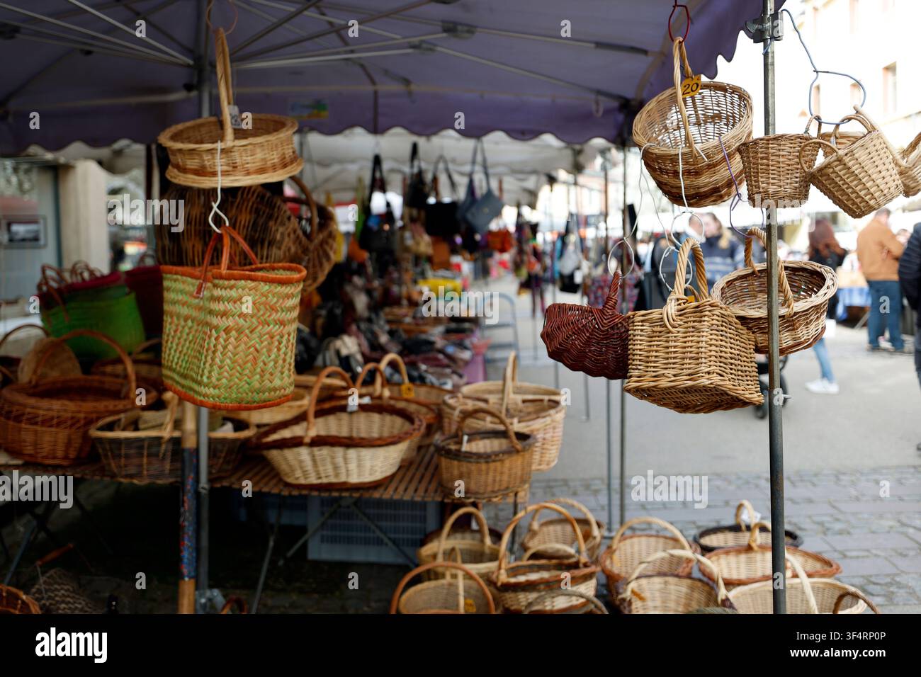 Traditionelle handgefertigte Körbe, die unter einem Baldachin auf einem Straßenmarkt hängen und gestapelt sind. Stockfoto