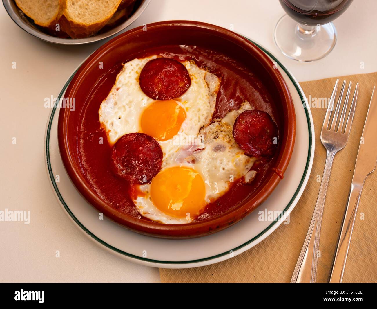 Spiegeleier mit Chorizo und Tomatenpaste in der Pfanne Stockfoto