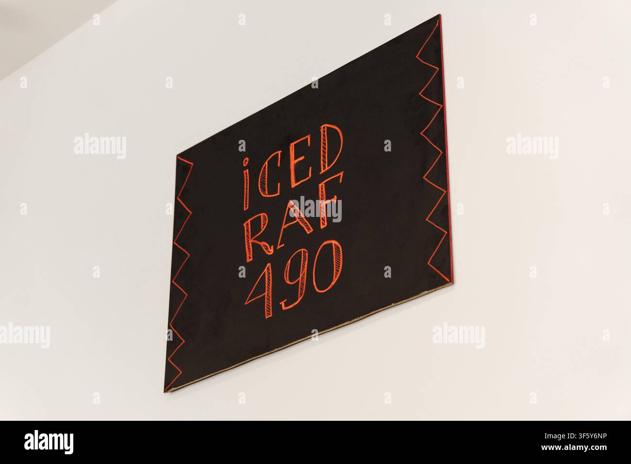 Minimalistisches Wandschild, das Eiskaffee im Inneren eines modernen Spezial Cafés bewirbt. Stilvolles Innendetail für das Branding von Cafés. Stockfoto