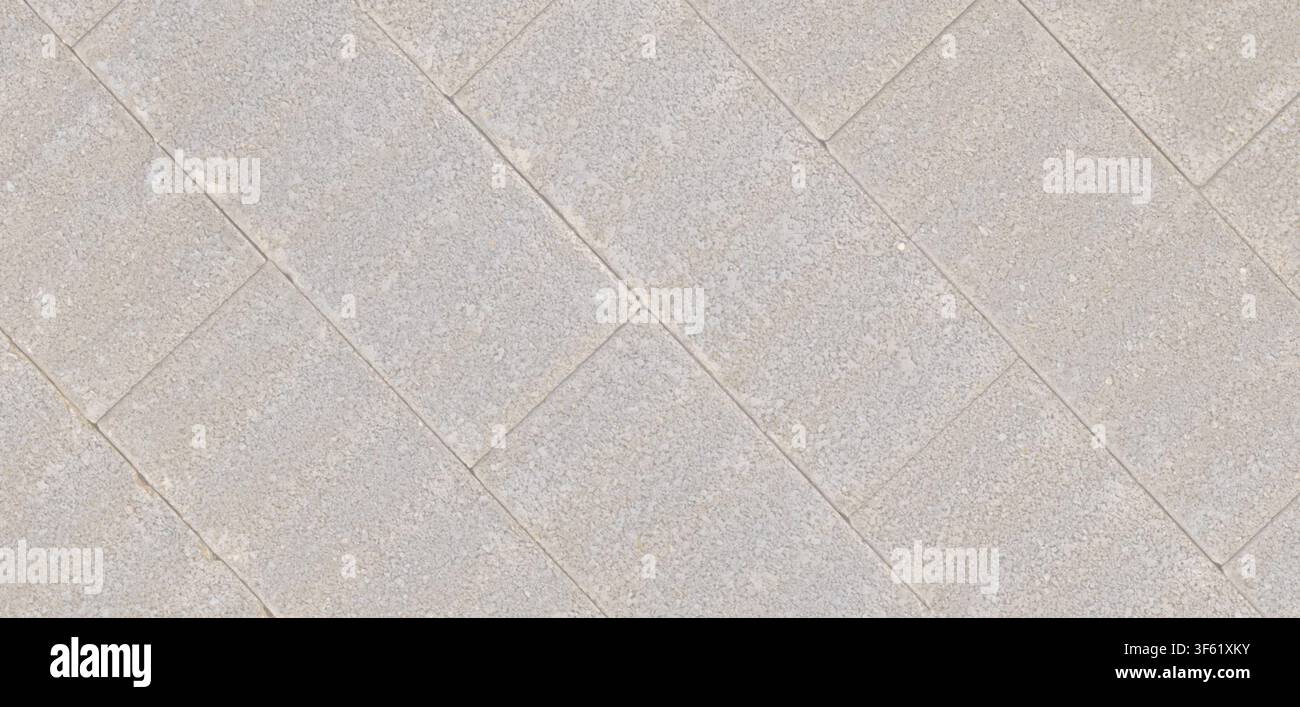 Diagonales Layout von rechteckigen hellgrauen Betonpflastersteinen mit dünnen Mörtelfugen. Stockfoto
