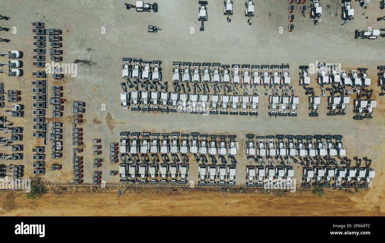 Mini-Bagger, die neben einer Fabrik aufgereiht sind Stockfoto