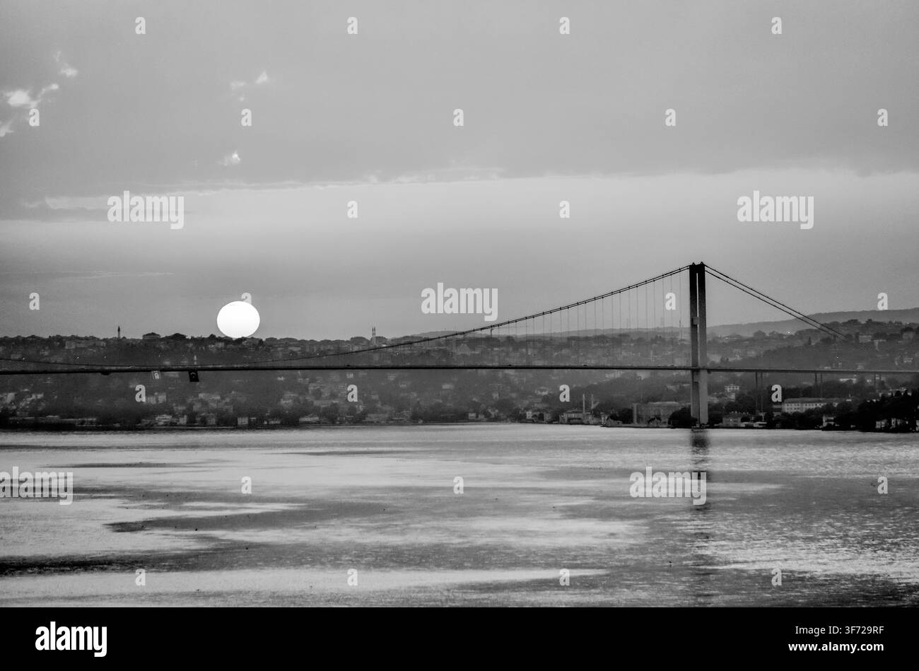 Sonnenaufgang über dem Bosporus mit der 15. Juli-Märtyrerbrücke in Istanbul, Türkiye. Stockfoto