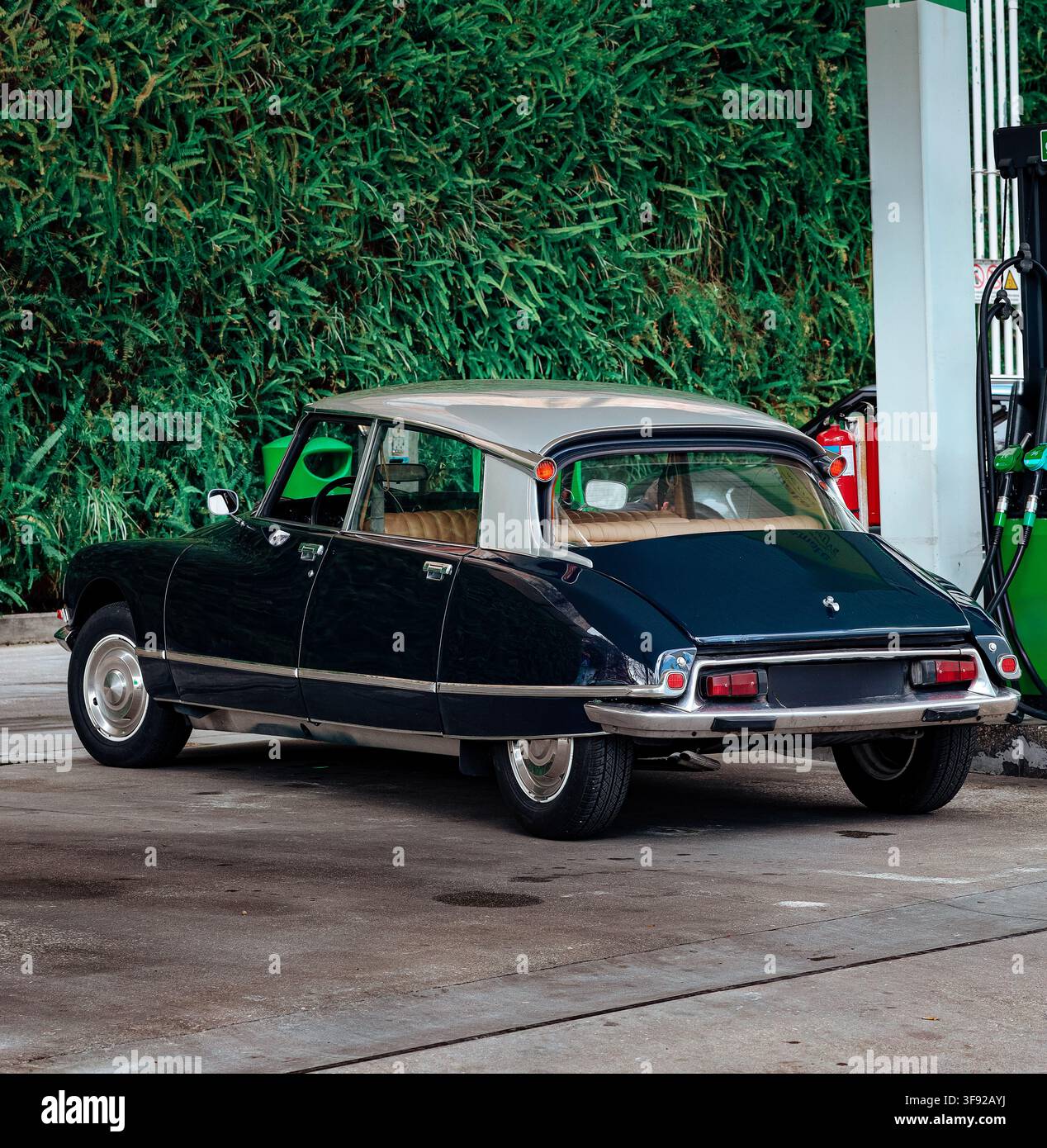 Klassisches Oldtimer-Auto an einer Tankstelle geparkt Stockfoto