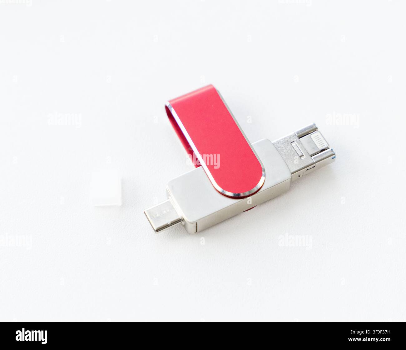 Ein roter und silberner USB-Stick liegt auf einem weißen Hintergrund Stockfoto