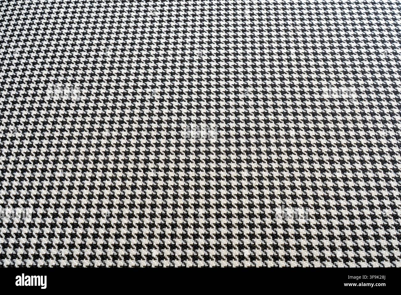 Schwarz-weißes Hundszahn-Textilmuster mit feiner gewebter Textur und sich wiederholendem geometrischem Design, nahtloser Modestoffhintergrund Stockfoto