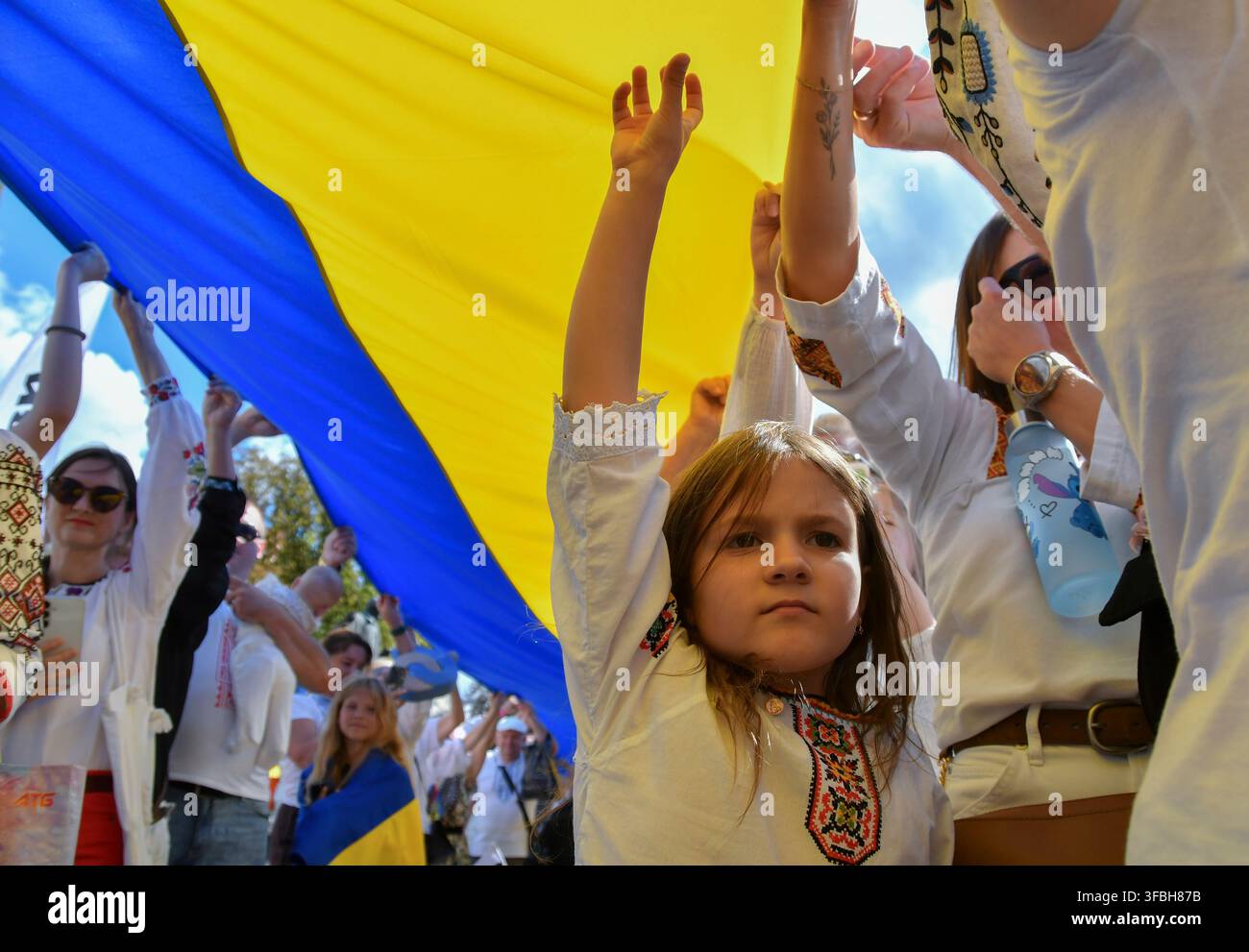Ukrainer halten eine 35 Meter lange Nationalflagge während einer öffentlichen Veranstaltung zur Feier des Nationalflaggentages in Lemberg, Westukraine, am 23. August 2026. Der Nationalflaggentag wird jährlich in der Ukraine am 23. August begangen, um eines der wichtigsten Staatssymbole des Landes zu ehren. Stockfoto