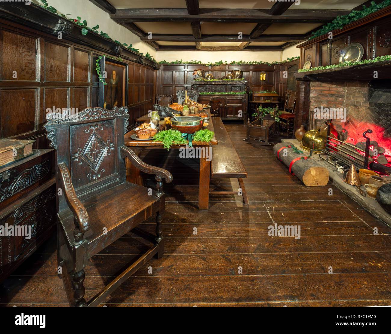 Langer Tisch, Kamin und festliche Grünpflanzen in der Ausstellung "Weihnachten im 17. Jahrhundert" im York Castle Museum. Stockfoto