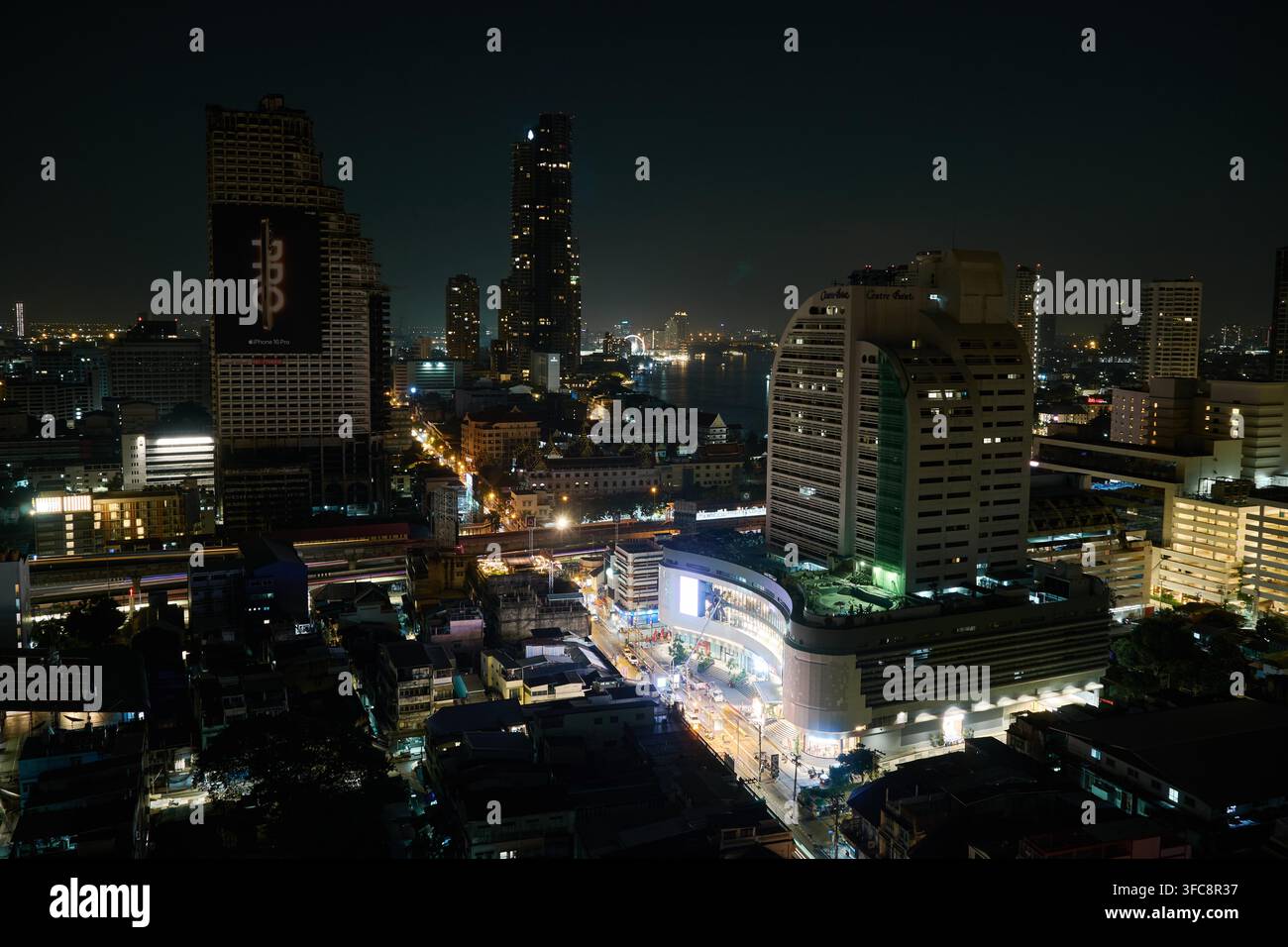 Bangkok-Himmelstadt bei Nacht, gesehen vom Lebua-Hotel, Thailand, mit dem verlassenen Sathorn Unique Tower deutlich sichtbar. Stockfoto
