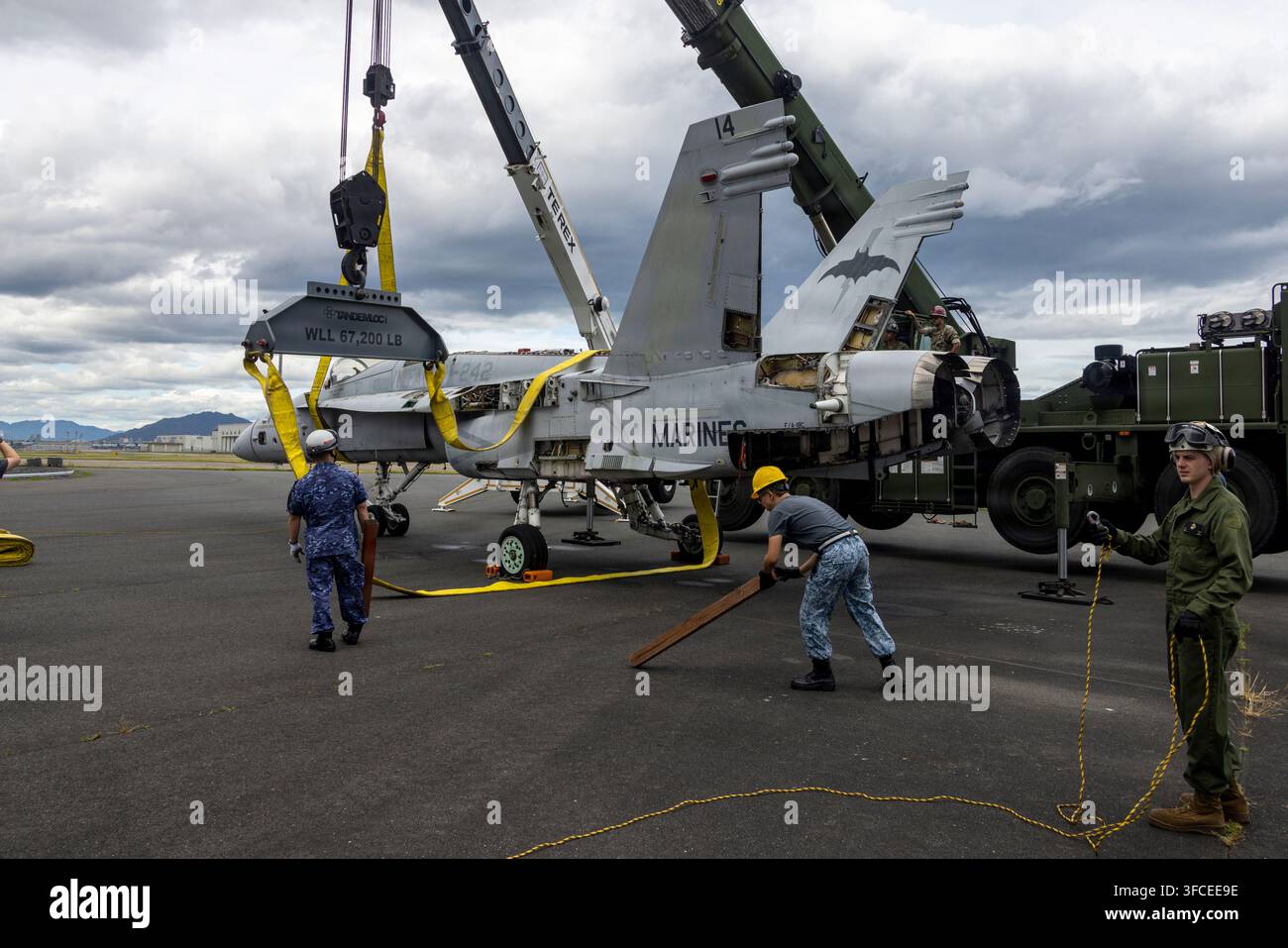 U.S. Marines, Mitglieder der Japanischen Seeschutzkräfte und singapurische Dienstmitglieder bereiten sich darauf vor, ein simuliertes abgestürztes Flugzeug während Crash Da zu hissen Stockfoto