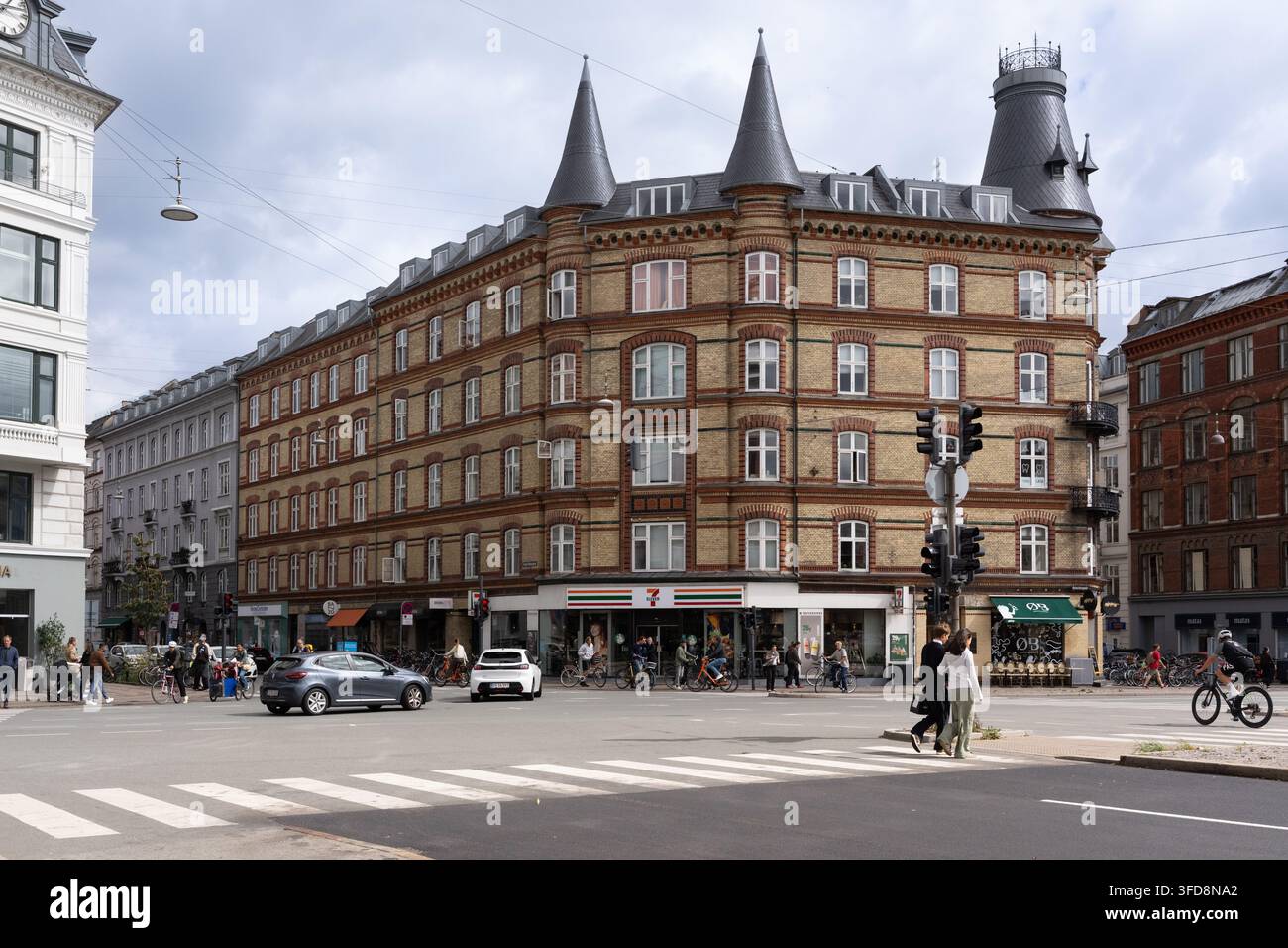 Einwohner radeln und gehen durch die belebte Kreuzung Trianglen in Kopenhagen an einem typischen geschäftigen Tag. Stockfoto