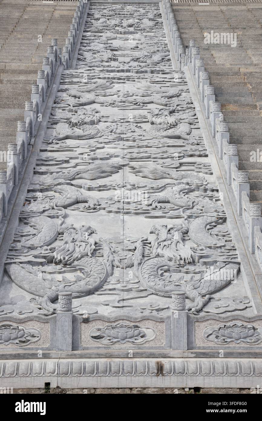 Der steinern geschnitzte kaiserliche Weg auf den Treppen eines traditionellen chinesischen alten Gebäudes, mit lebhaften Drachen- und Wolkenmustern, die in die Steinplatten geschnitzt sind Stockfoto