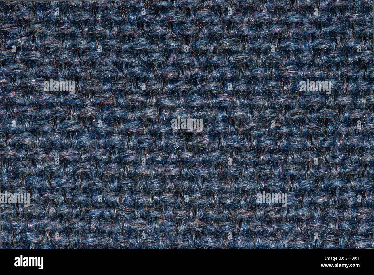 Navyblauer Wollstoffgewebe-Fadenfarbenmuster mit hellen Flecken. Stockfoto