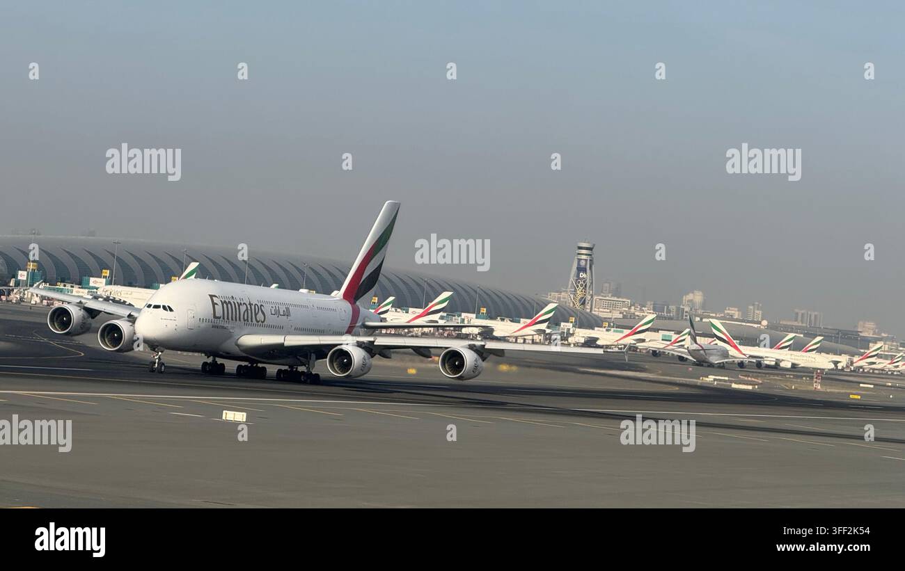 Durch ein Bullauge an Bord einer Airbus 380, während eine weitere Airbus 380 am Dubai International Airport in Dubai in den Vereinigten Arabischen Emiraten abhebt - Smartphone-aufgenommenes Stockfoto