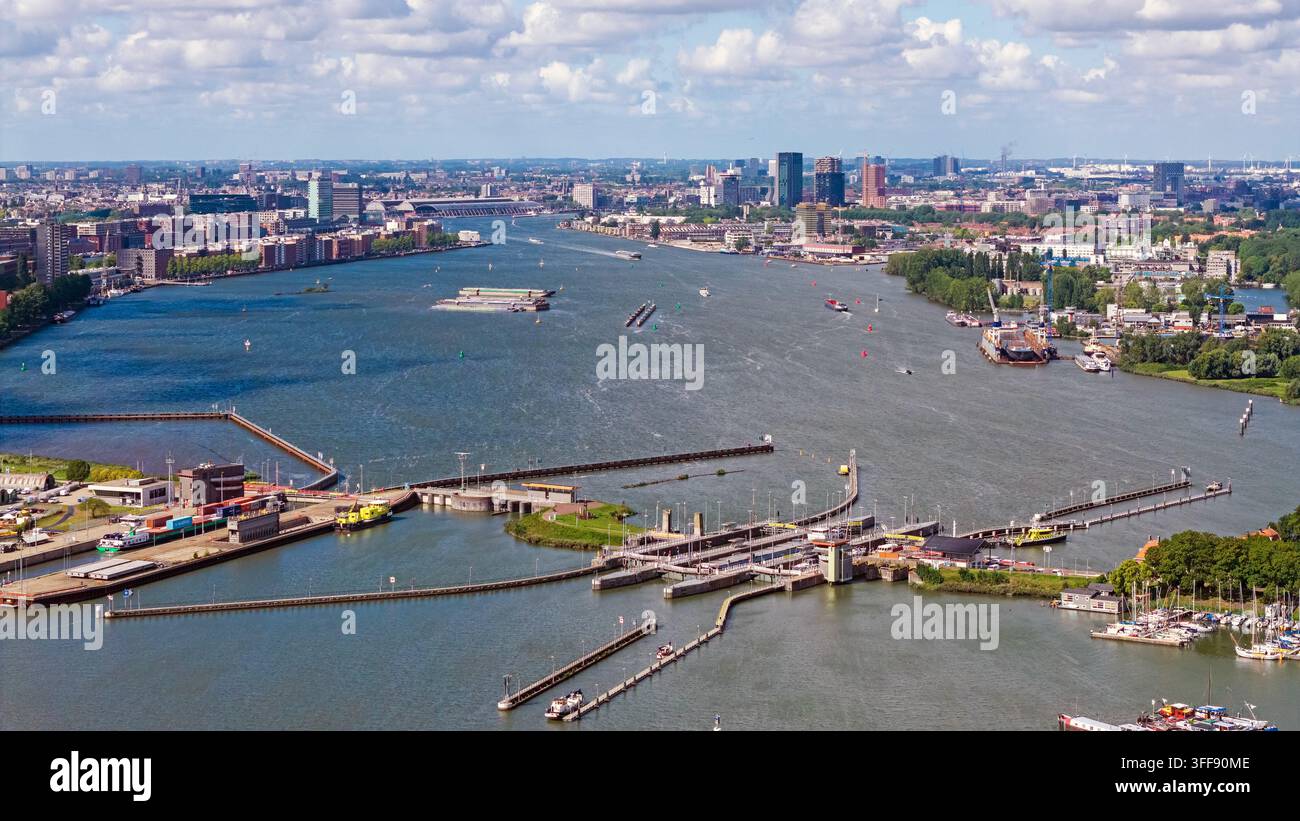 Luftbild des Oranjesluizen-Schlussanlagenkomplexes mit umliegenden Wasserwegen, industrieller Infrastruktur und der Stadtsilhouette von Amsterdam, Amsterdam, Nr. Stockfoto