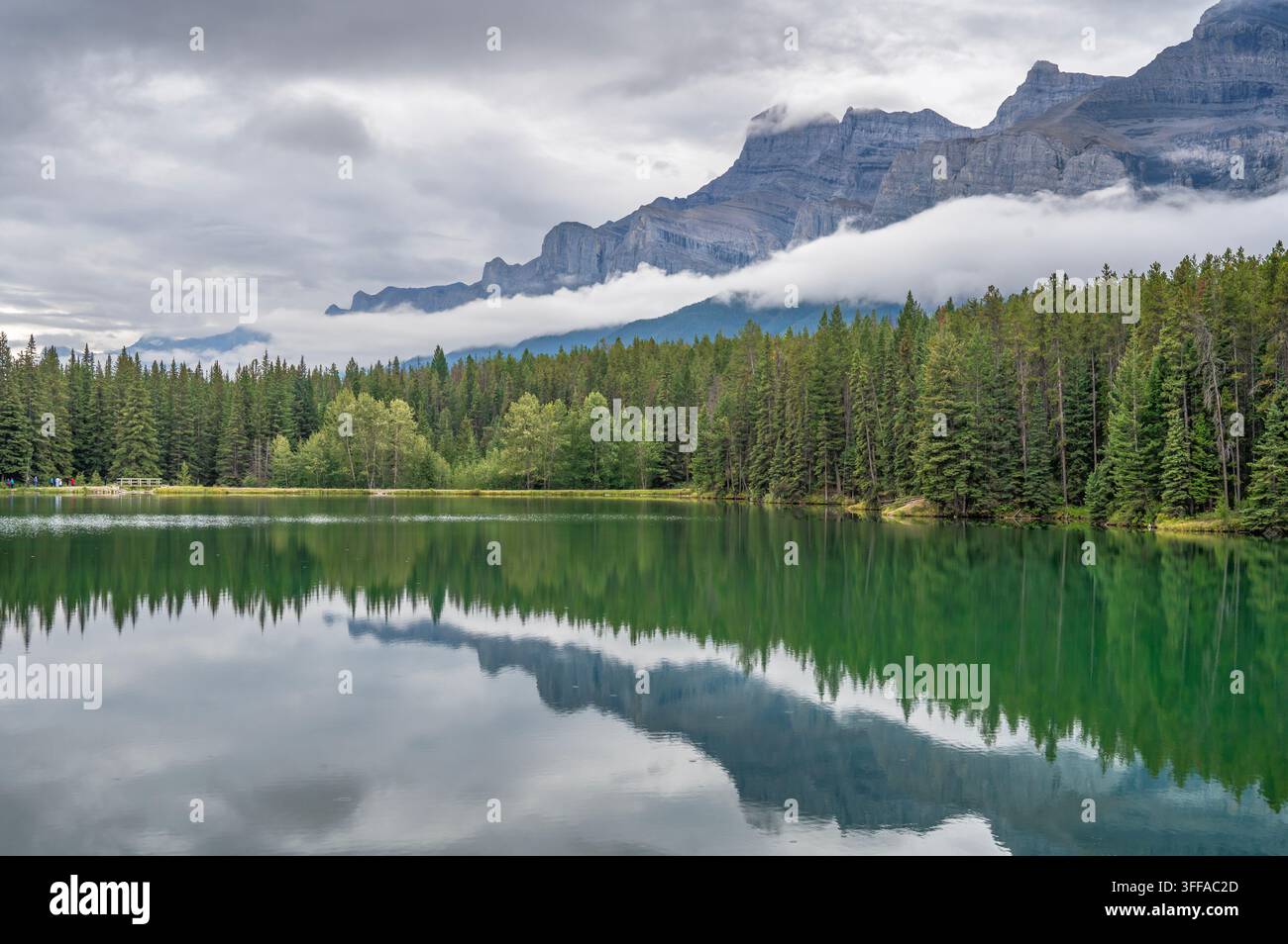 Wolke bedeckt den Mount Rundle und den Johnson Lake im Banff-Nationalpark, Alberta, Kanada Stockfoto