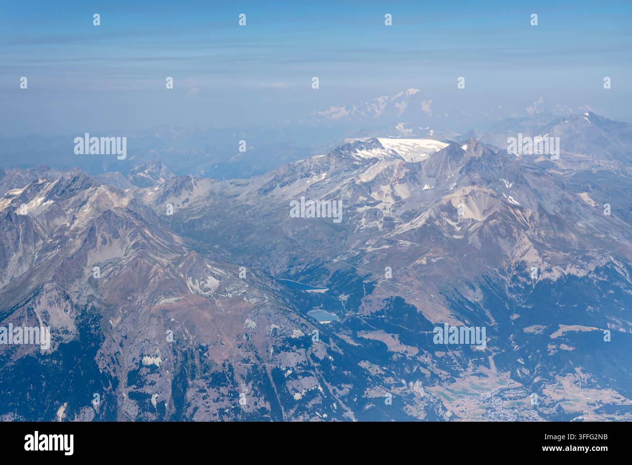 Luftbildlandschaft mit der Bergkette Dent-Parrachee und dem Monte-Bianco-Gipfel, der im fernen Hintergrund aufragt, aufgenommen von einem Gleitschirmflugzeug im hellen Sommerlicht Stockfoto