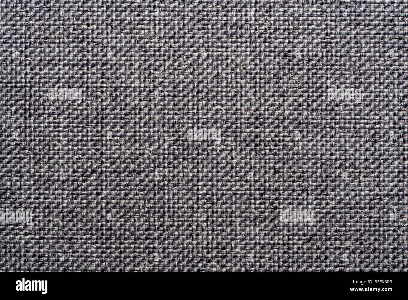 Grauer Polsterstofftexturhintergrund mit Leinwandgewebe. Nahaufnahme grauer Textilmaterial-Leinwandhintergrund abstrakter dunkler Melange-Baumwolle oder Leinen pa Stockfoto