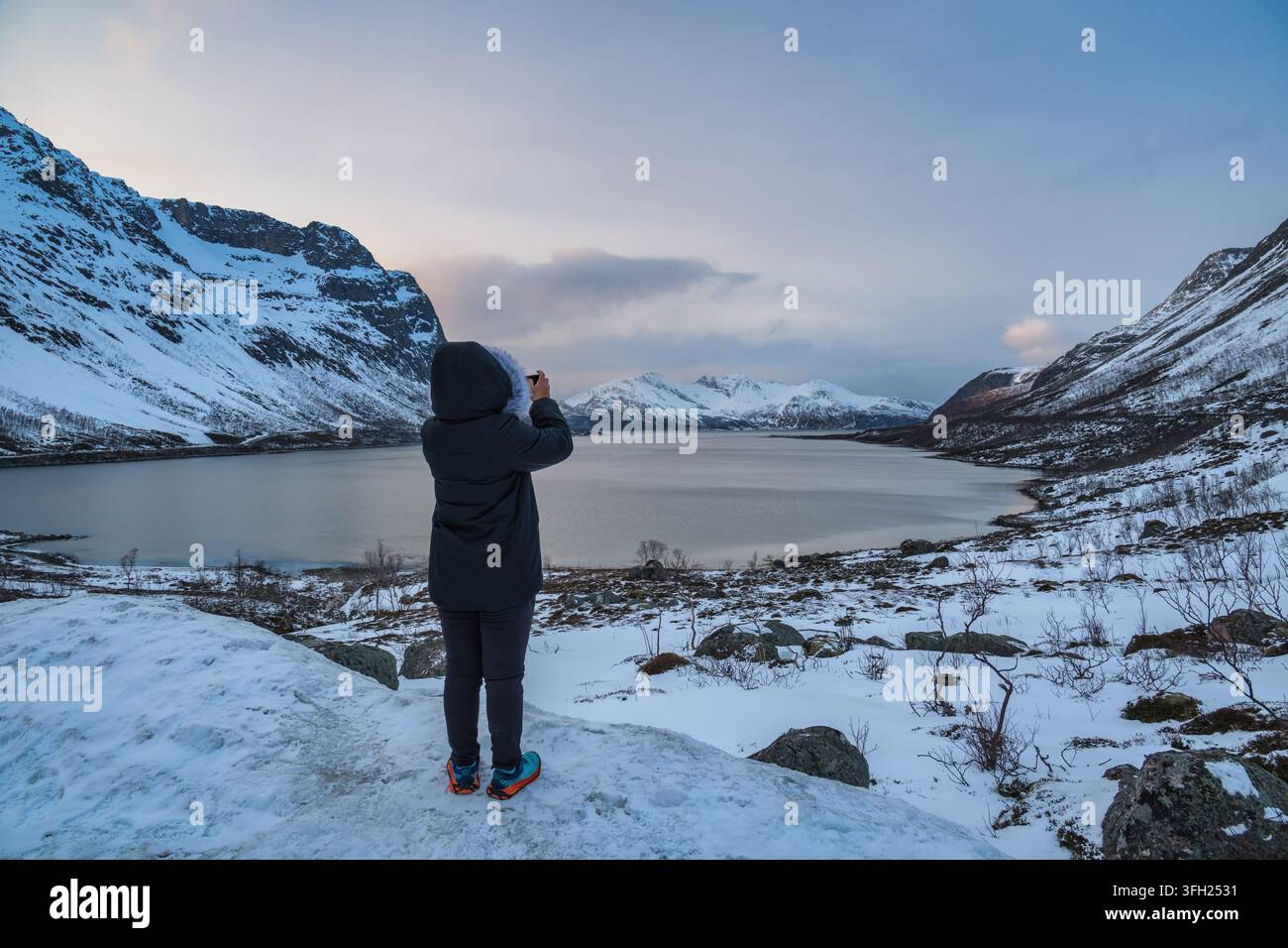 Tromso Norwegen, Touristin macht Foto von der Winterlandschaft in Grotfjord Stockfoto