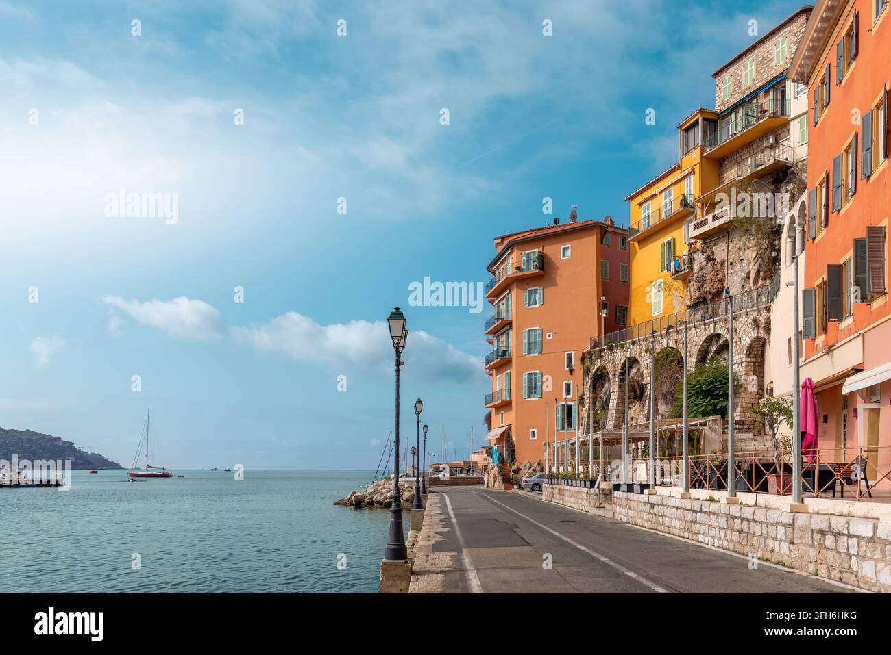 Farbenfrohe Ufergebäude säumen die historische Altstadt von Villefranche-sur-Mer, mit Blick auf das ruhige Mittelmeer entlang der malerischen französischen Riviera Stockfoto