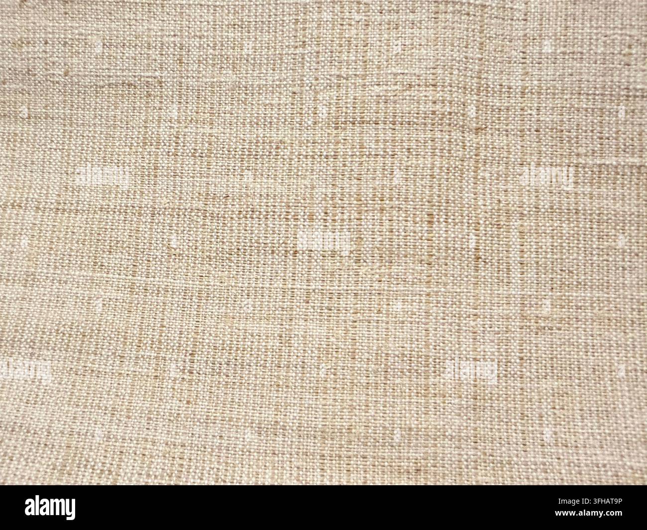 Natürlicher beiger gewebter Textilhintergrund mit feiner Stofftextur Stockfoto