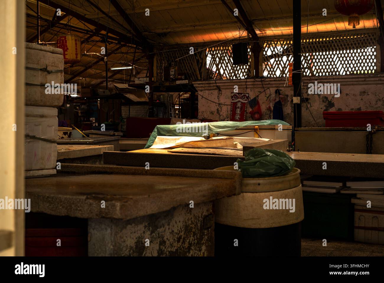 Leere Stände in einem traditionellen asiatischen Feuchtmarkt bei schwachem Licht Stockfoto
