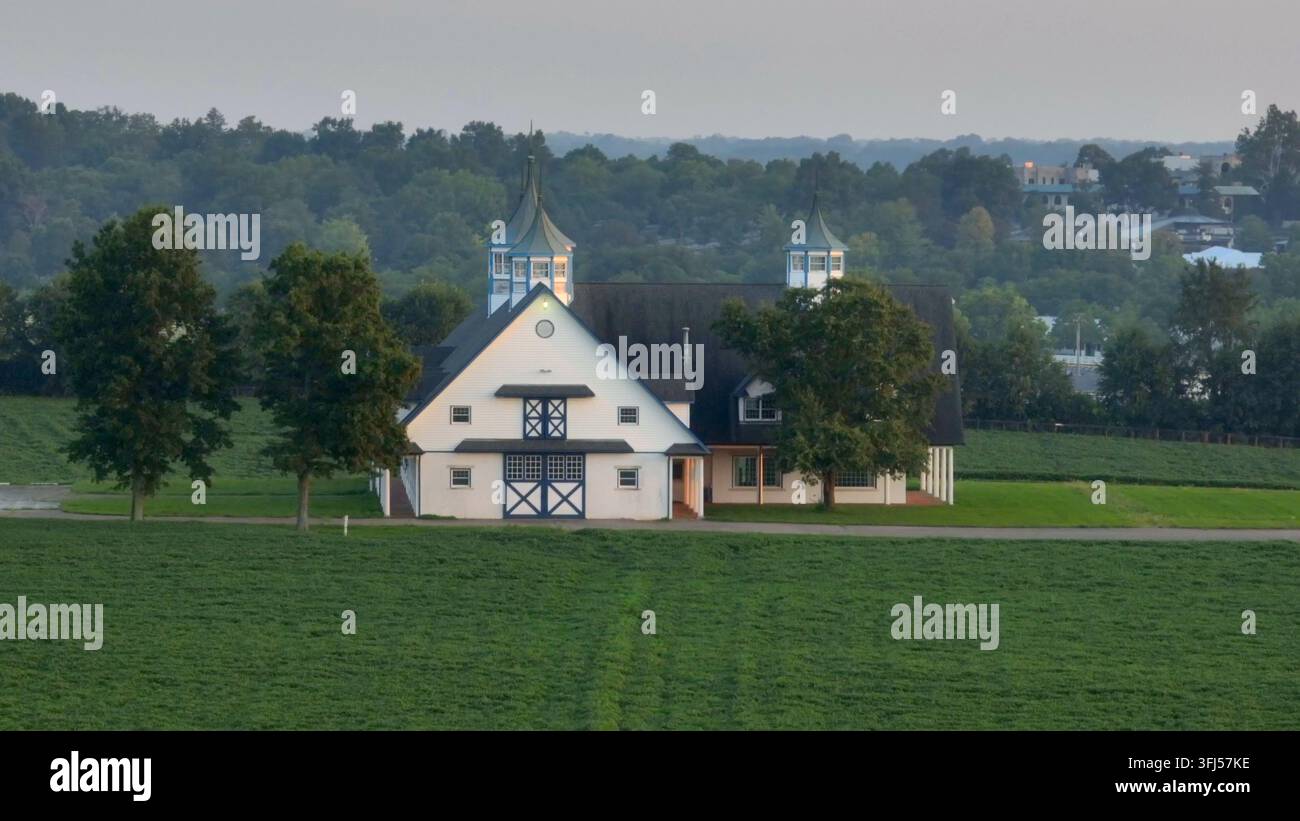 Ställe und Scheune auf der Pferdefarm Keeneland in Lexington, Kentucky. Luftaufnahme der malerischen Szene während des Sonnenuntergangs im Pferdeland Lyndon. Stockfoto