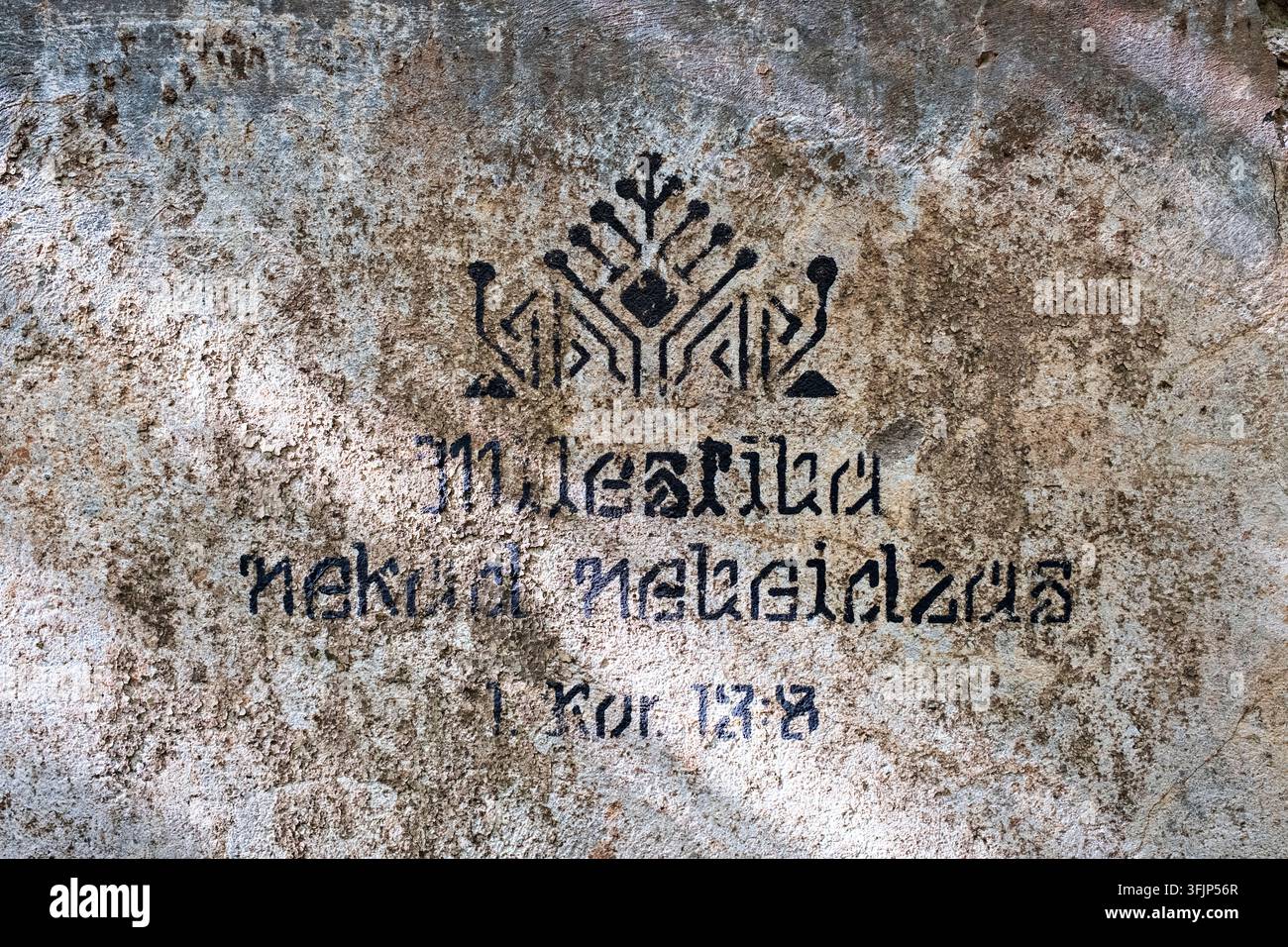 Die Liebe hört nie auf - Bibelvers - Schrift an der Wand in den Ruinen des Herrenhauses Seja, Lettland Stockfoto