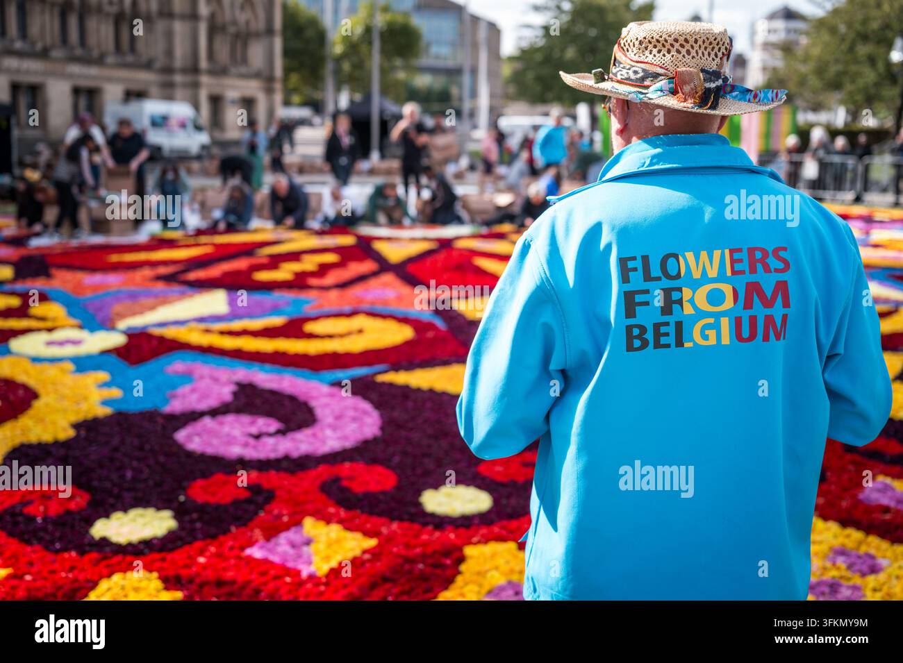 Bradford, West Yorkshire, England: Freiwillige waren im Zentrum von Bradford eifrig dabei, einen wunderschönen Blumenteppich zu gestalten. Rund 330.000 Dahlien Stockfoto