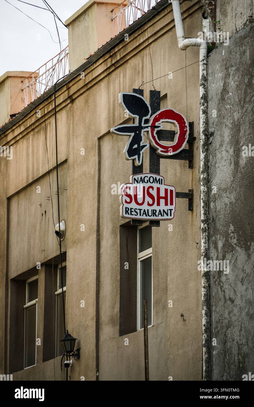 Ulaanbaatar, Mongolei – 03. September 2017: Eine vertikale Aufnahme der Außenseite des Nagomi Sushi Restaurants mit zwei Schildern an einer beigen Gebäudefassade; die Stockfoto