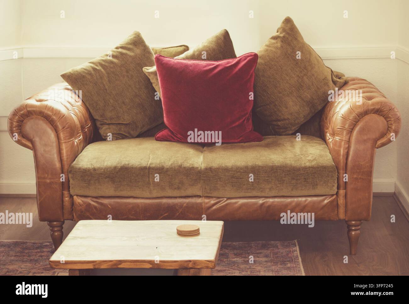 Chesterfield-Sofa aus Leder mit bunten Kissen Stockfoto