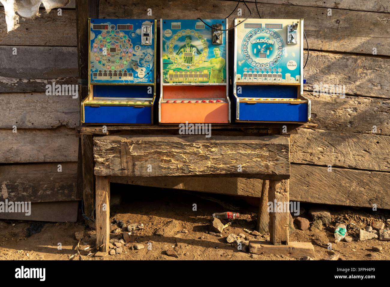 Alte Münzbetriebene Arcade-Spielmaschinen, die außerhalb eines Holzladens montiert sind, Zentralregion, Elmina, Ghana Stockfoto