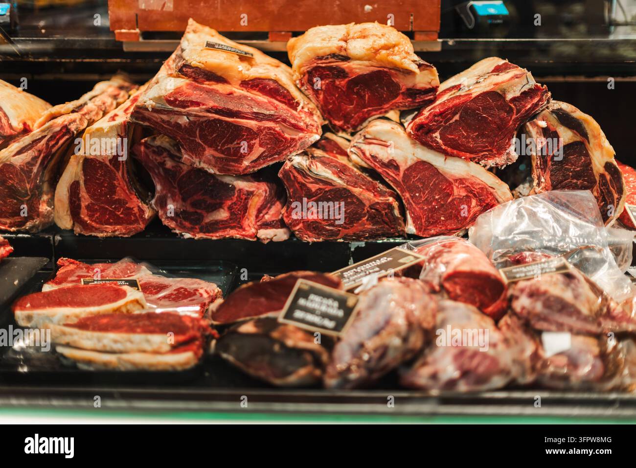Nahaufnahme verschiedener roher Rindfleischstücke, die auf einem Markt in Barcelona in Spanien ausgestellt sind. Stockfoto
