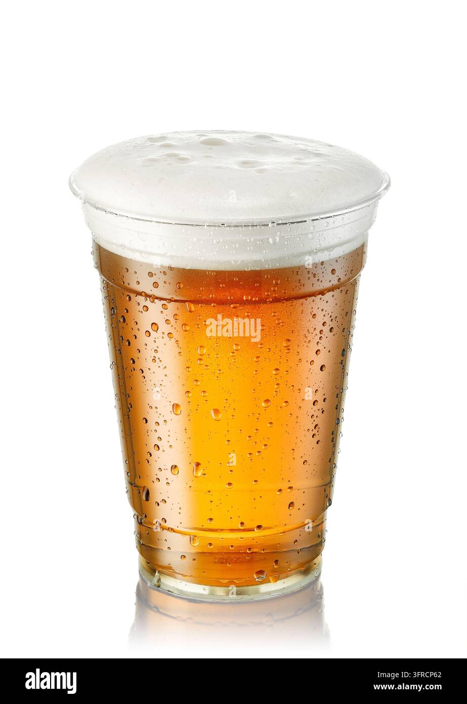 Bier mit schaumiger weißer Haube und sichtbaren Kondenswassertropfen in einem wegwerfbaren Plastikglas isoliert auf weißem Hintergrund Stockfoto