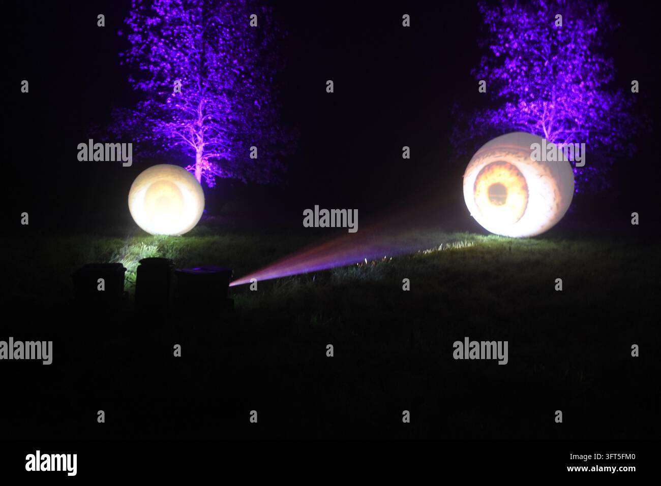 Riesige Augapfel-Lichtinstallation auf einem nächtlichen Parkfest im Freien Stockfoto