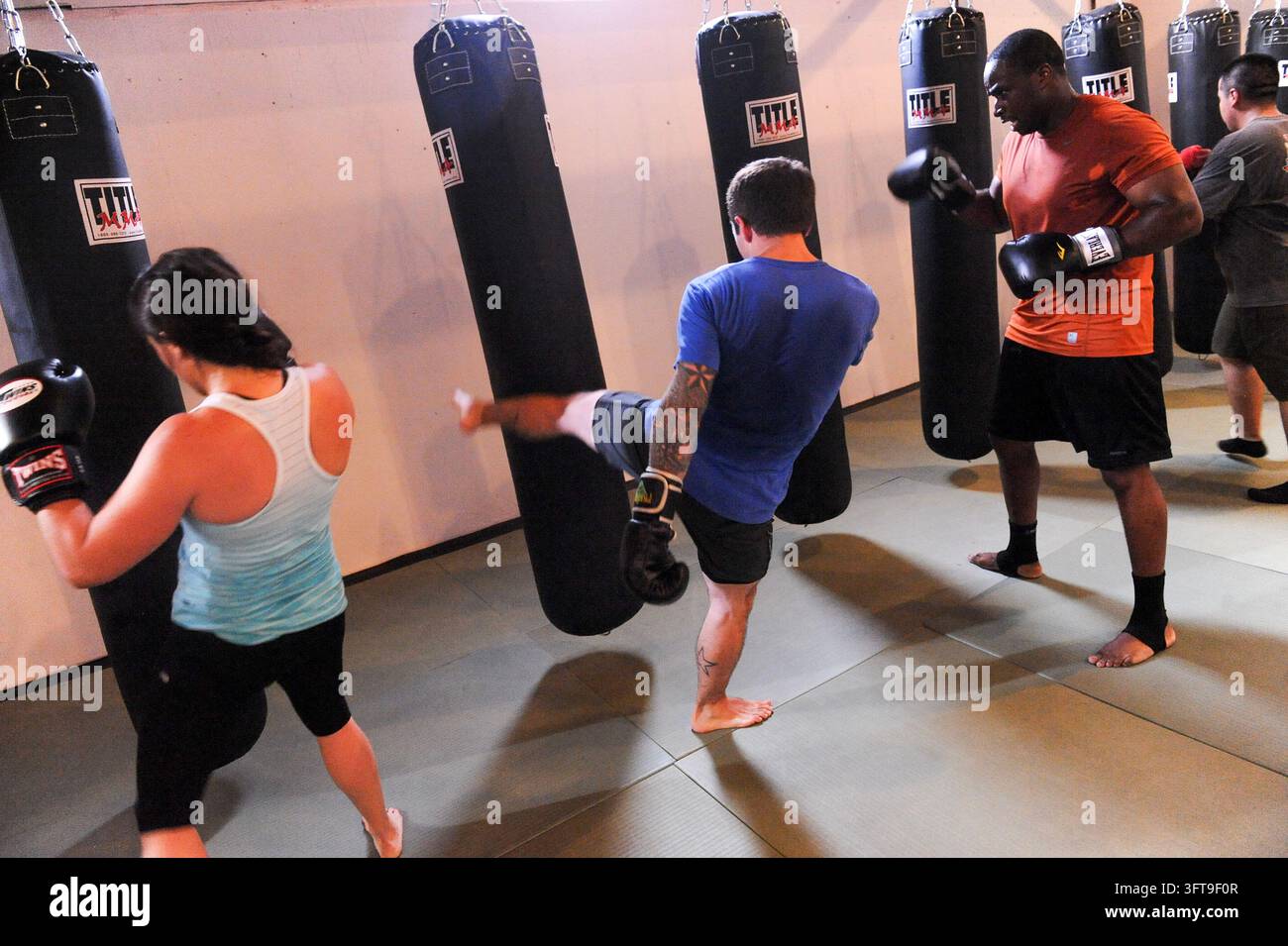 Fitnessstudio-Besucher trainieren mit hängenden schweren Säcken im Eastside Austin Elite, Austin, Texas, am 16. Juli 2013. (Foto von John Anderson/The Austin Chronicle) Stockfoto